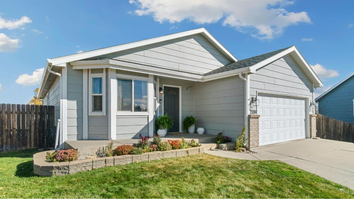 Beautiful home and front yard with fresh plants on the porch, new gardens, new paint, and curb appeal upgrade